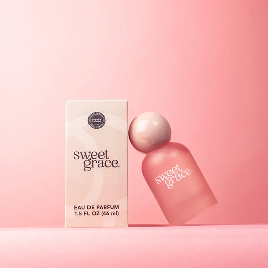 Sweet Grace perfume bottle and packaging on a pink background